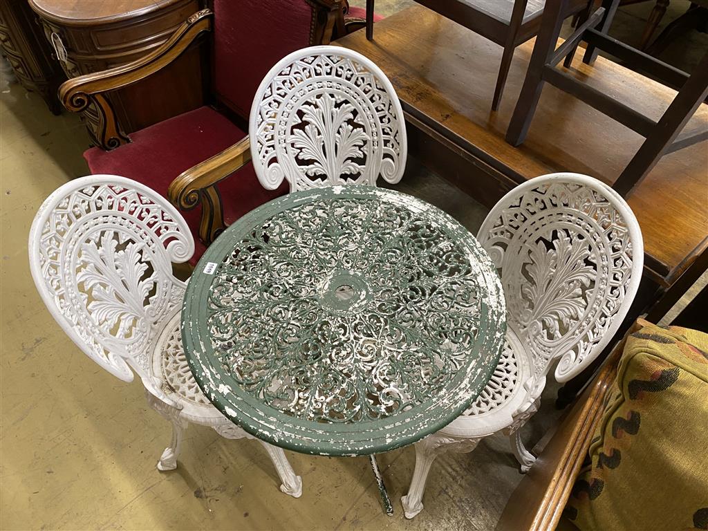 A circular painted aluminium garden table, diameter 68cm together with a set of four painted garden chairs